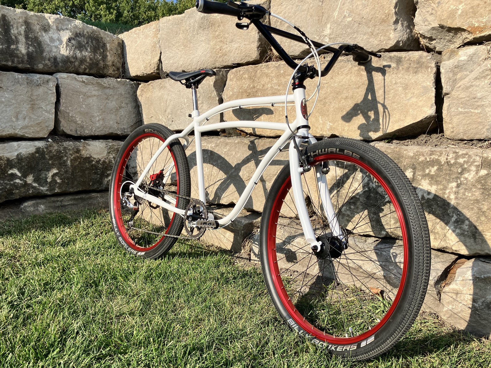 The complete bike, hanging out by some rocks.