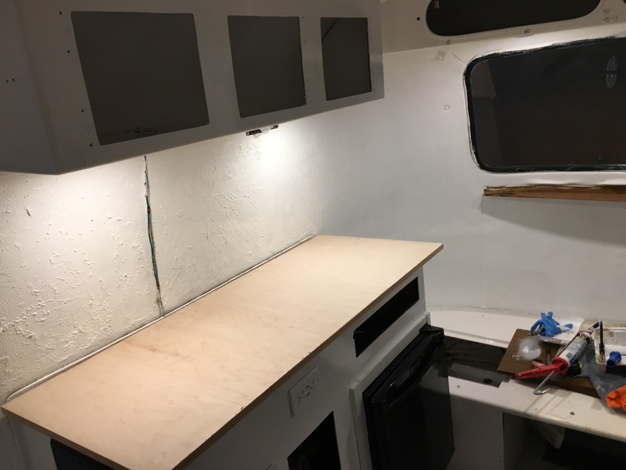 I also started test-fitting a new countertop I'd make from birch plywood.