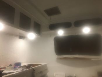 And now that there's power, let there by light. I got a great deal on a set of low-profile, dimmable remote control LED puck lights dirt cheap on Amazon Prime day and hard-wired them in. There are two at each end and two over the kitchenette, all controlled from a single remote. Six lights is plenty in a 60 sq ft trailer.