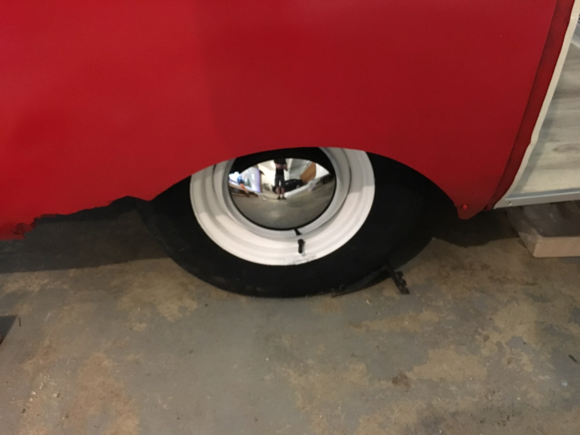 I painted the original wheels with Rustoleum white, too, and fitted some new baby moon hubcaps. You can also see some fiberglass damage from a long-ago blowout. Someday, when I get a pro paint job, I'll have that repaired. I did put new tires and bearings in, though.