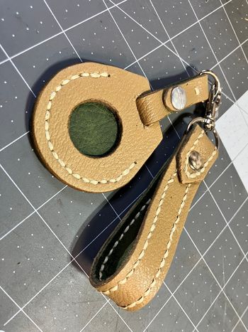 And eventually I had a wrist strap and airtag holder keychain made from the old leather, backed with some new green leather to match the exterior of the Jeep.